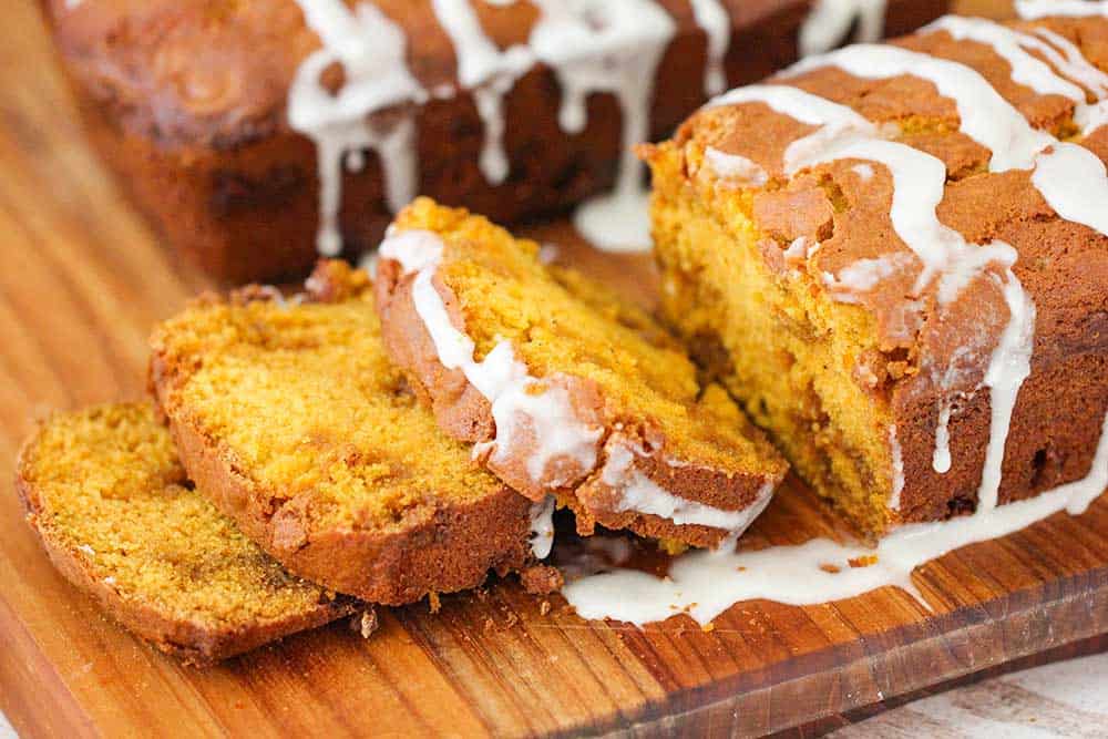 A close-up view of sliced pumpkin butterscotch bread on a cutting board. 