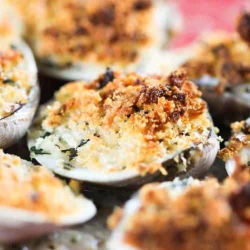 A red dish with baked clams