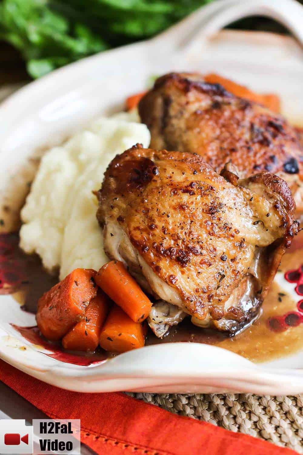 A plate of honey balsamic chicken with potatoes and carrots