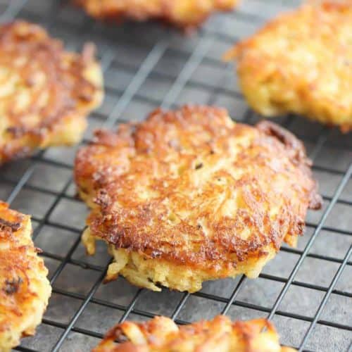 Latkes on a black wire cooling rack