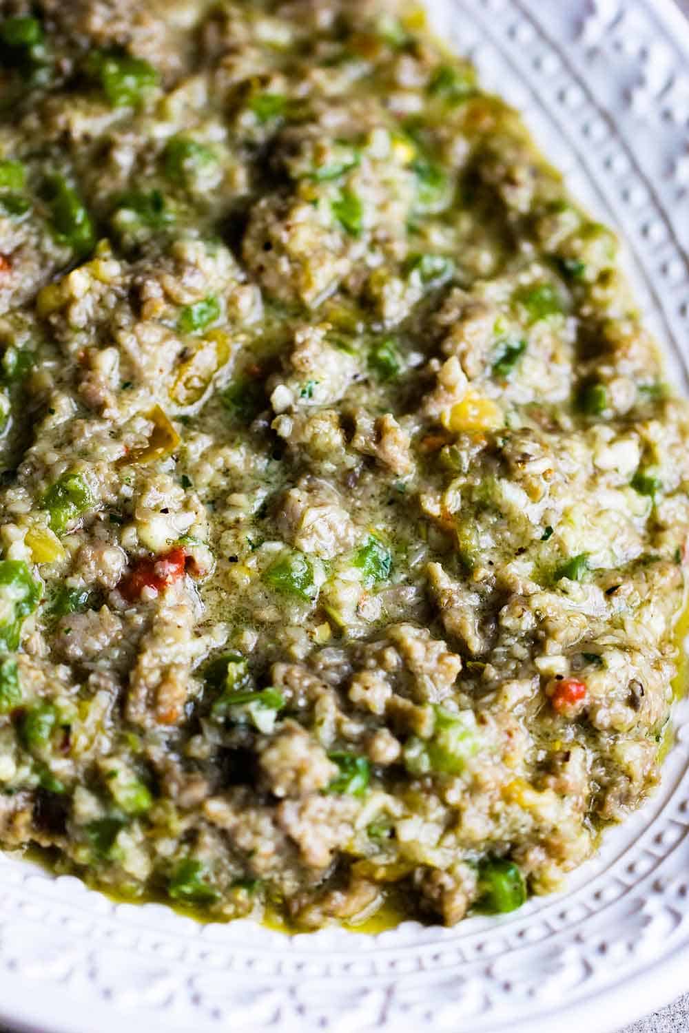 A platter of cooked sausage and breadcrumbs for filling mushrooms. 