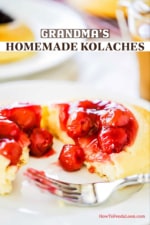 A cherry-filled Kolache that has been split in half on a white dessert plate.