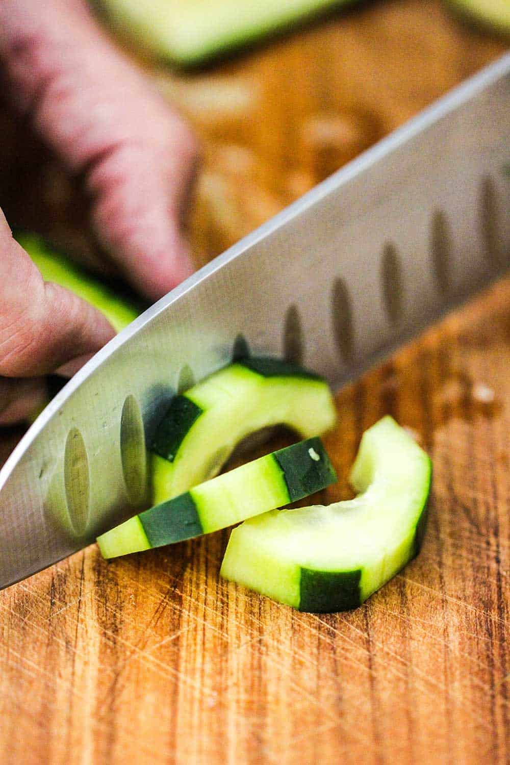 Use a sharp knife to slice the cucumbers into 1/4-inch pieces. 