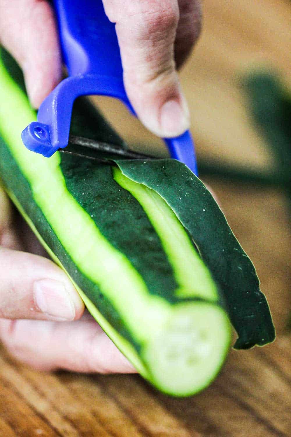 Peel the cucumber, leaving some of the skin on for a striped appearance. 
