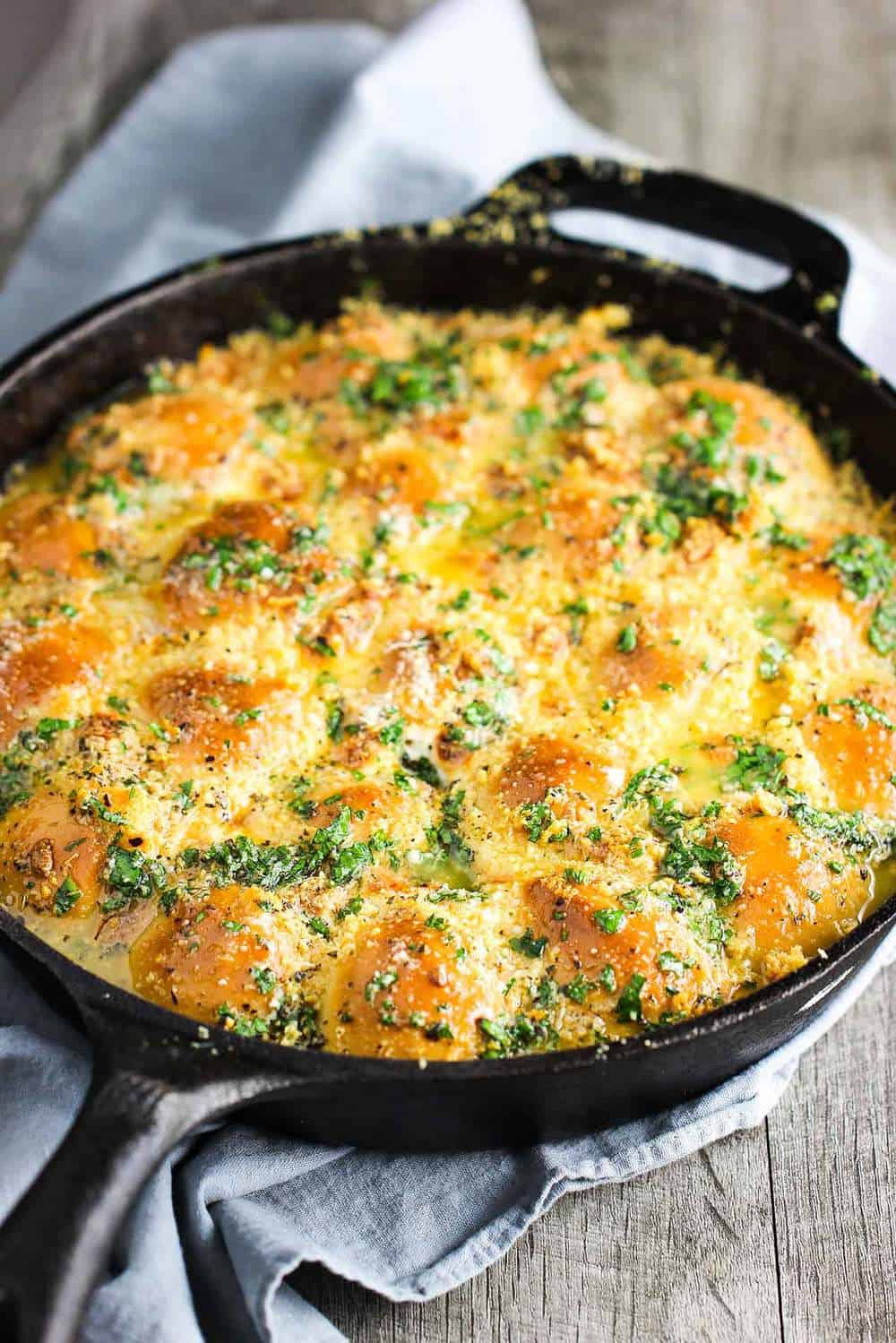 Freshly baked cheesy skillet rolls in a cast iron skillet