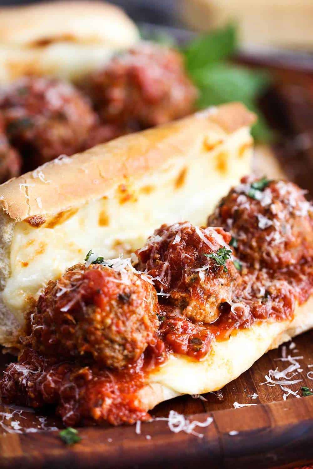 Meatball sub sandwich on a cutting board.