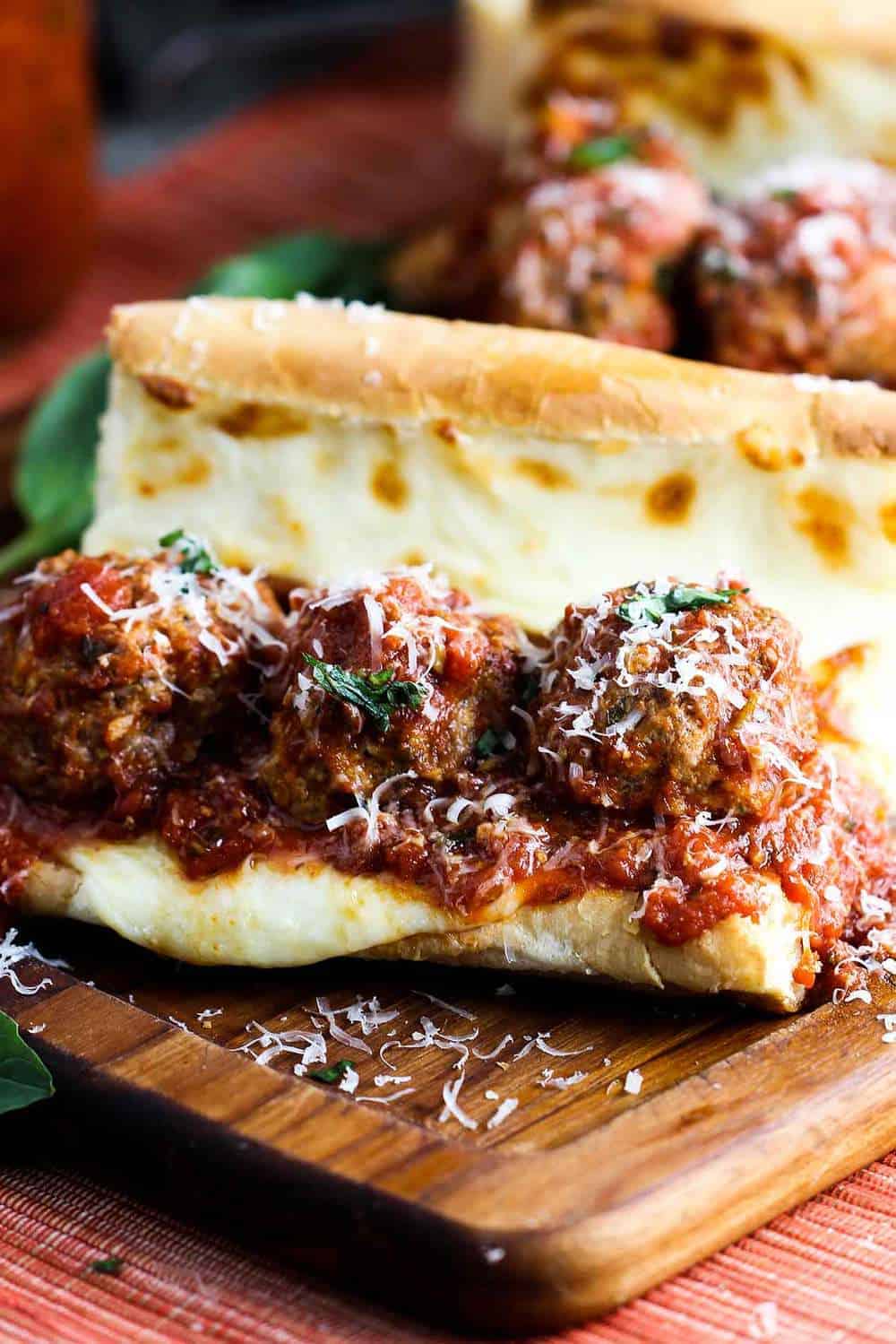 An Italian meatball sub sandwich on a cutting board 