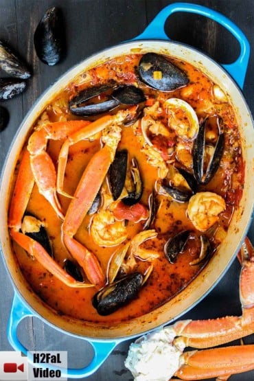 Classic cioppino in a large blue Dutch oven.