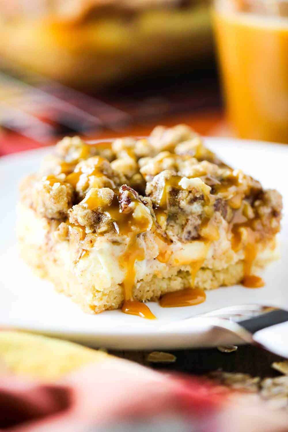 Cream cheese apple bars with pecan streusel on a white plate