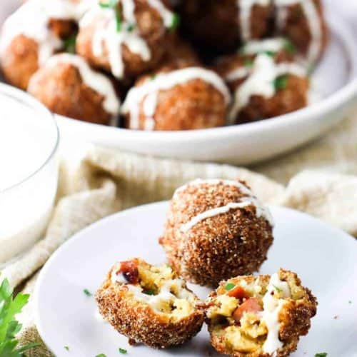 Smoked Sausage with Cheddar beignets on a white plate