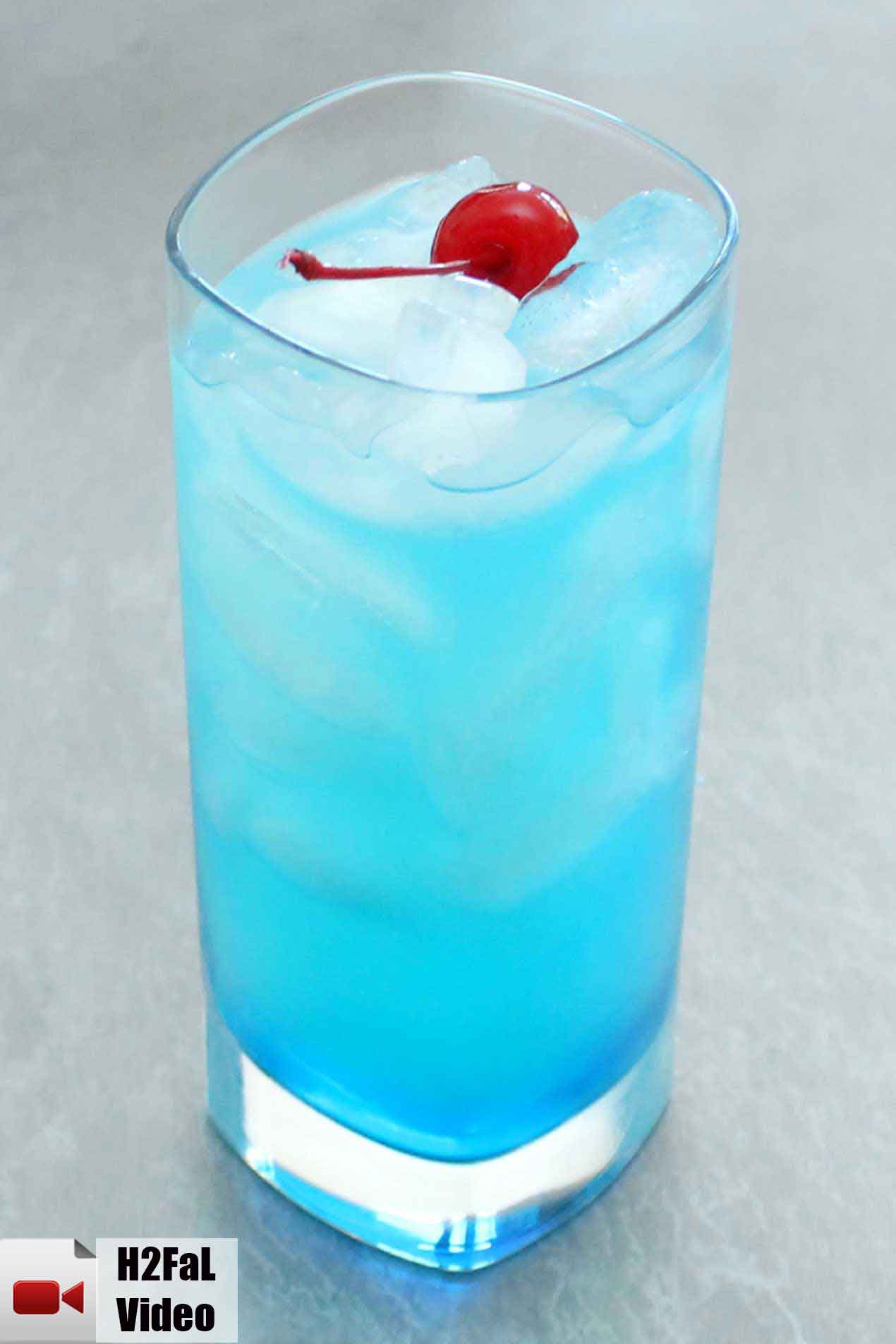 blue lagoon cocktail in front of a grey background