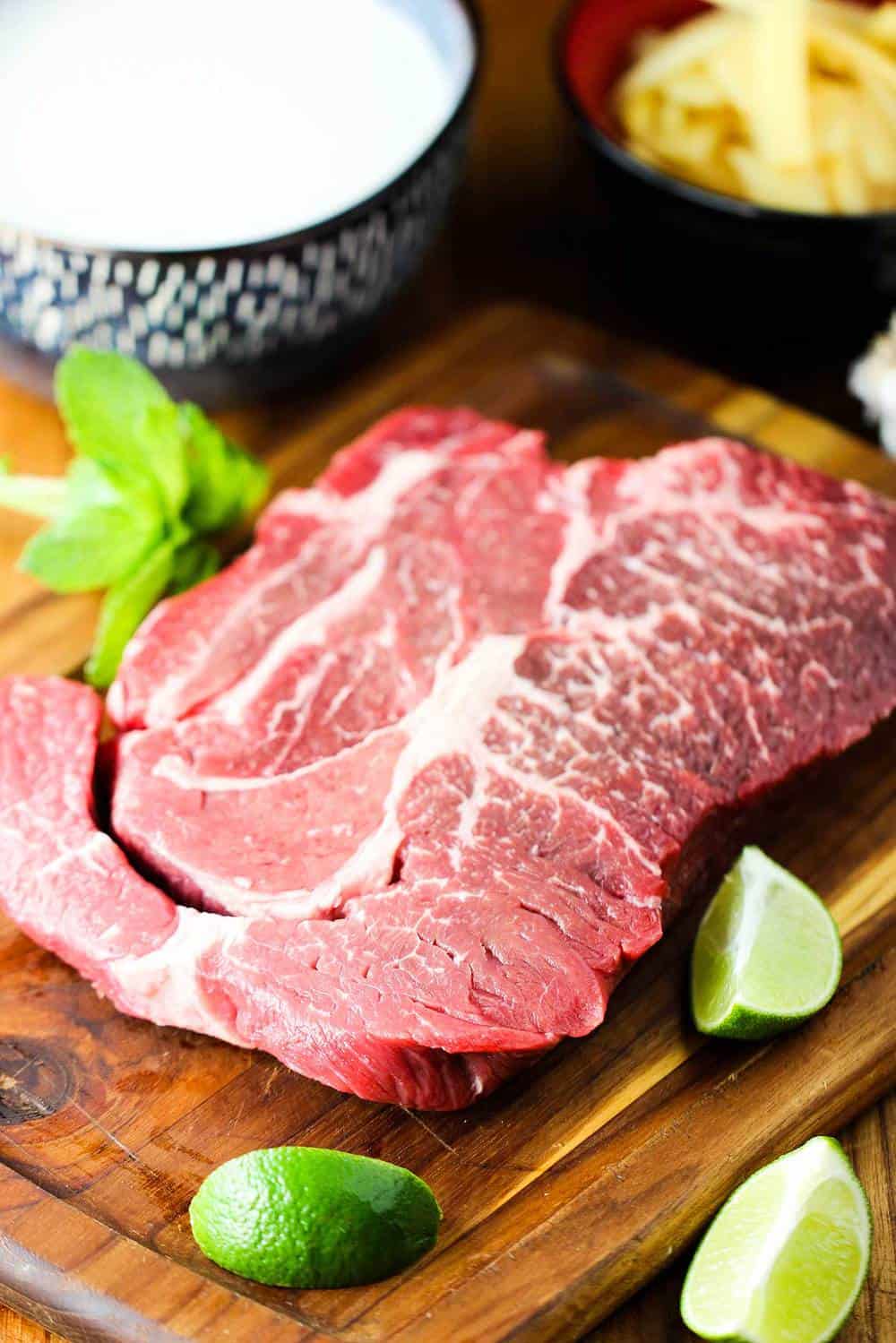 chuck roast on a cutting board for Thai Beef with Red Curry