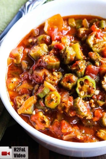 A white bowl holding stewed okra and tomatoes.