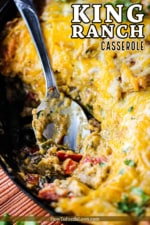 King Ranch casserole in a large cast iron skillet with a spoon in it