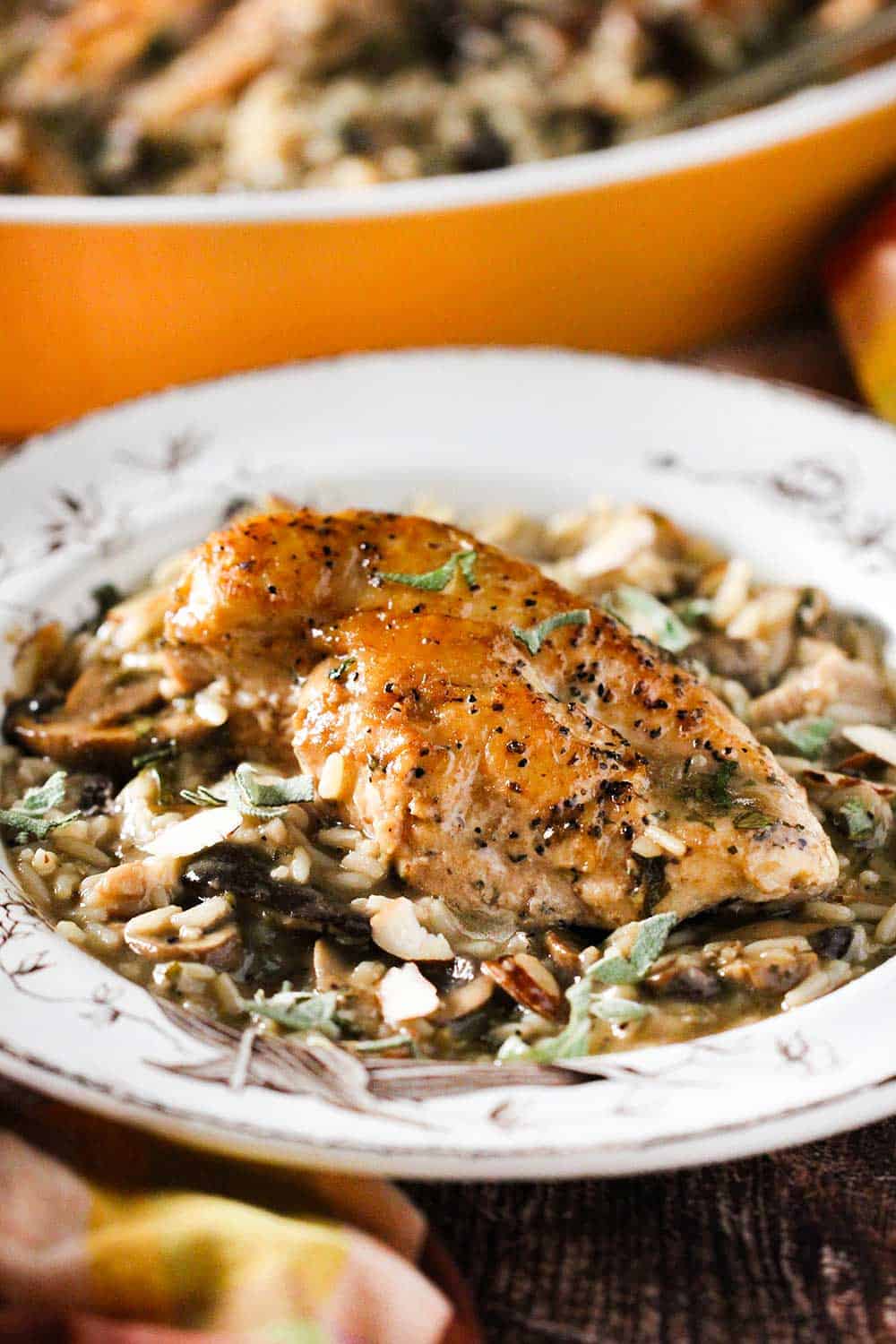 An antique plate holding a single serving of chicken and rice casserole. 