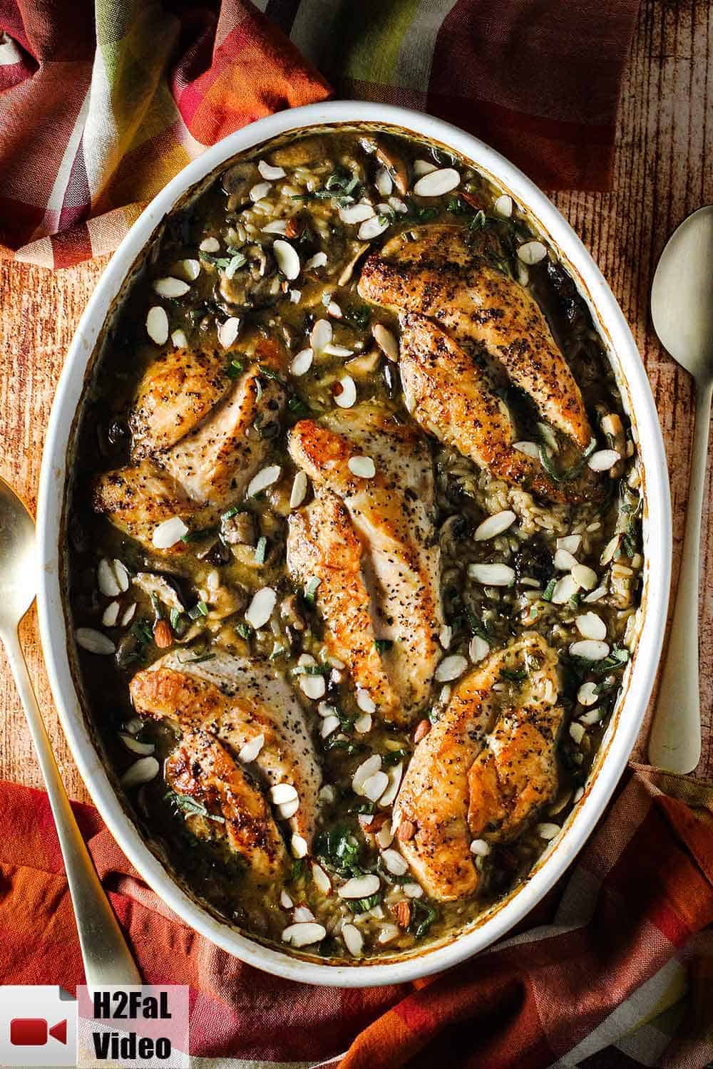 A large oval baking dish of baked chicken and sage casserole. 