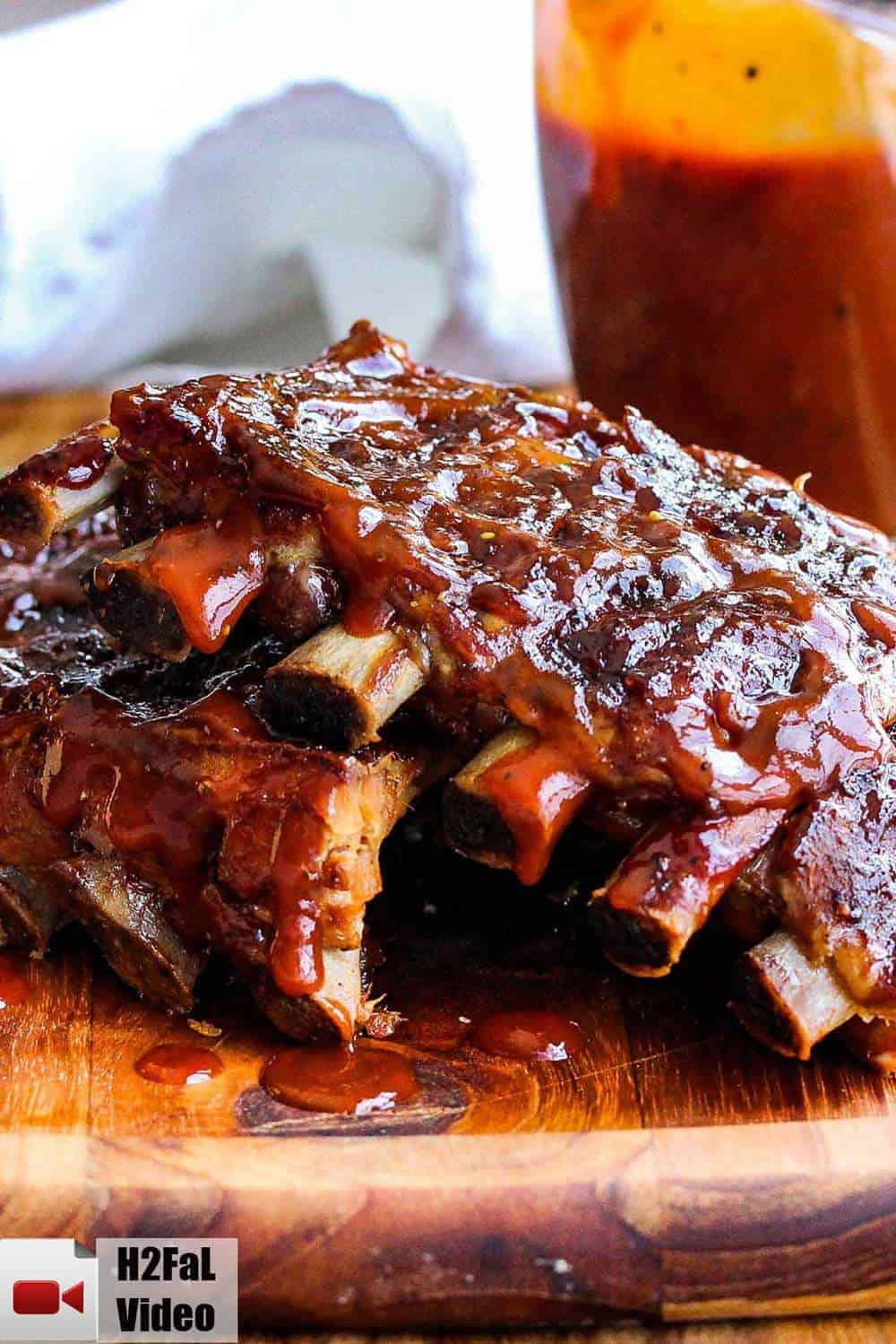 Slow cooker baby back ribs on a cutting board.