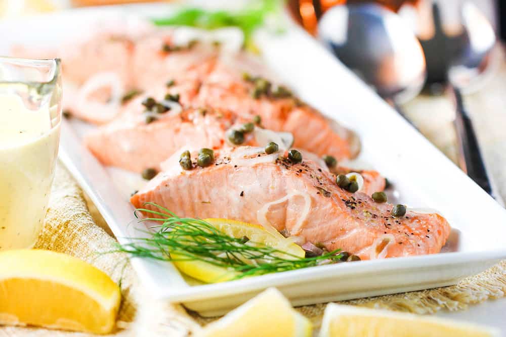 Poached salmon with capers and dill on a platter