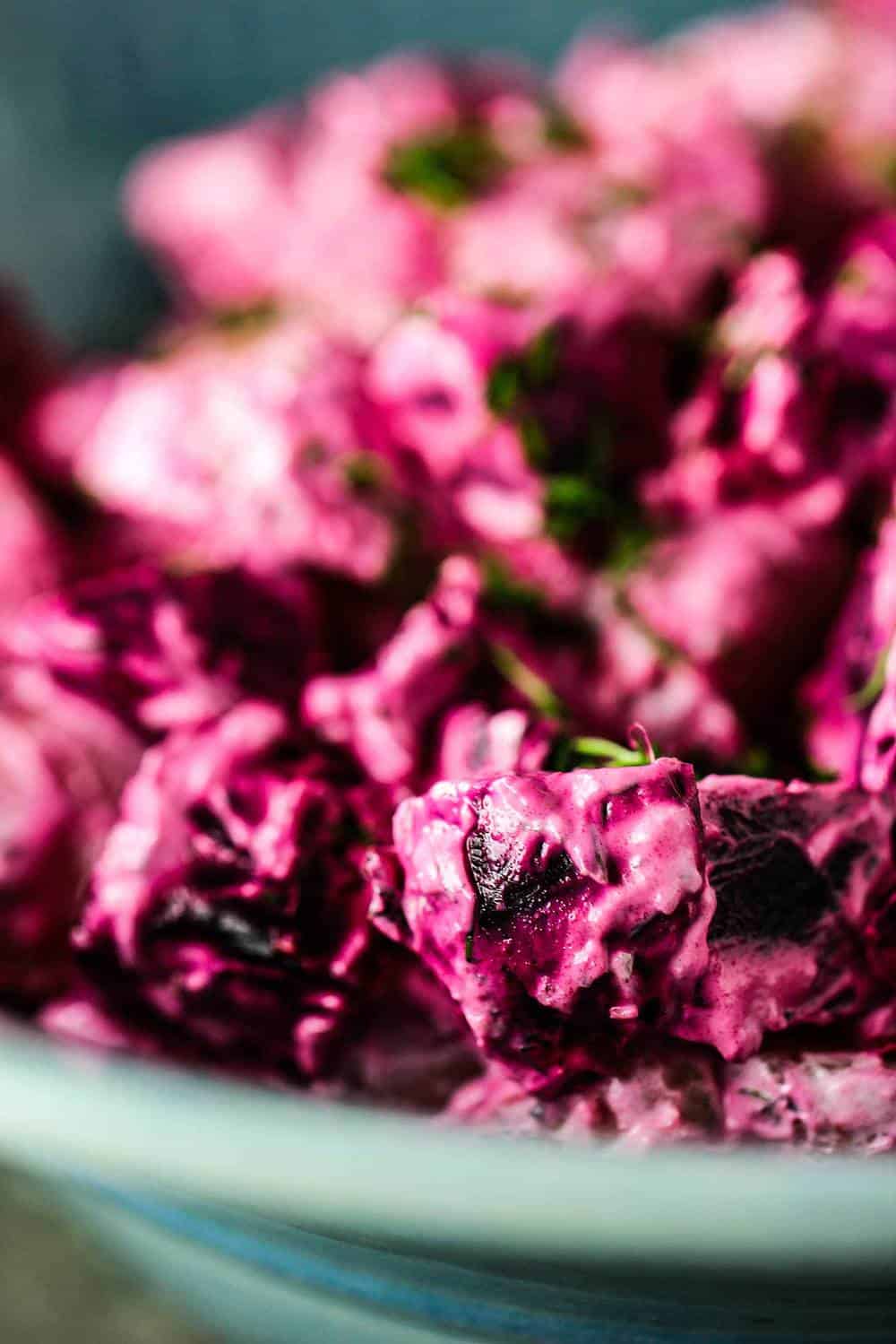 A close up view of red beet and potato salad with dill dressing