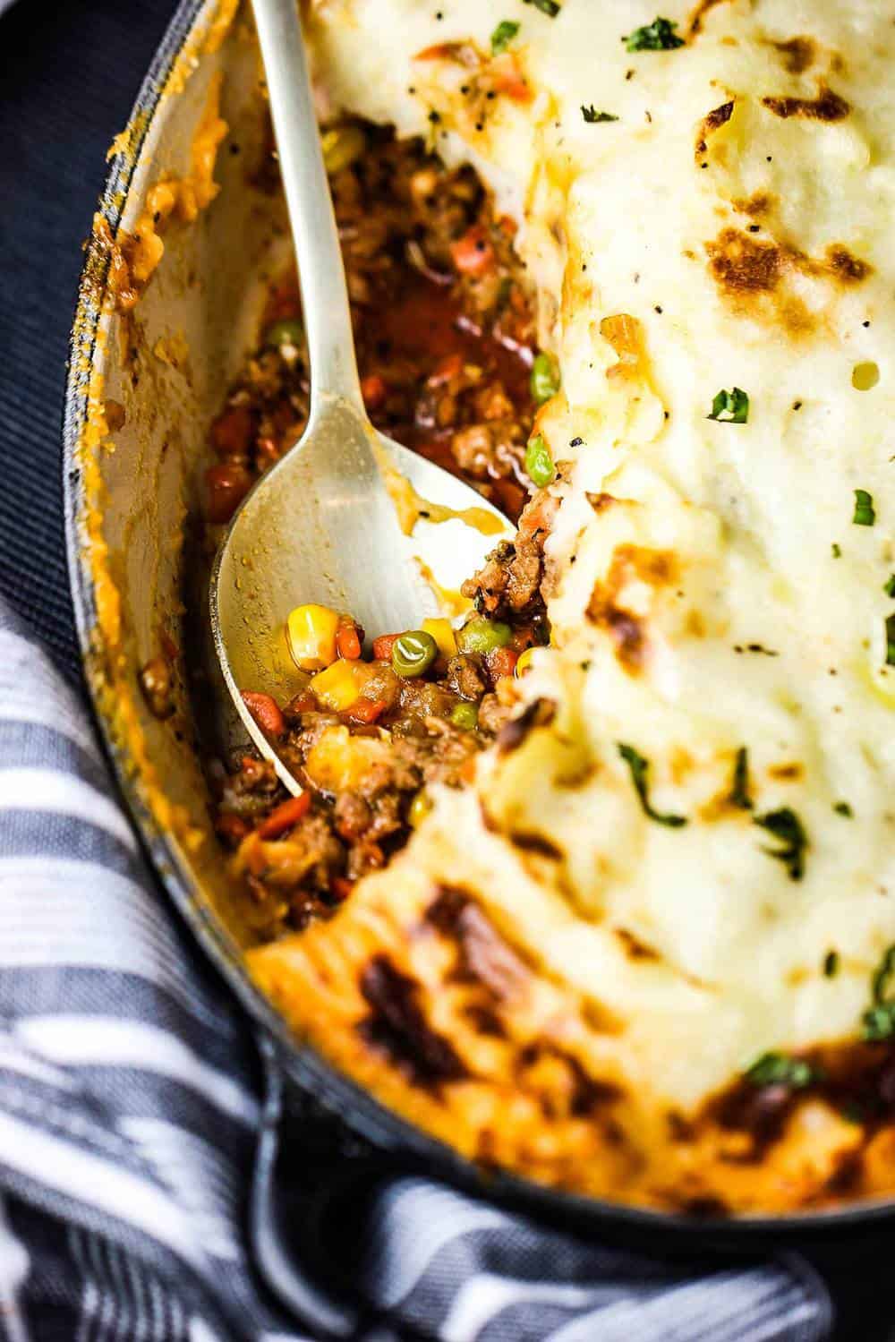 A gold spoon in a dish of homemade Shepherd's Pie