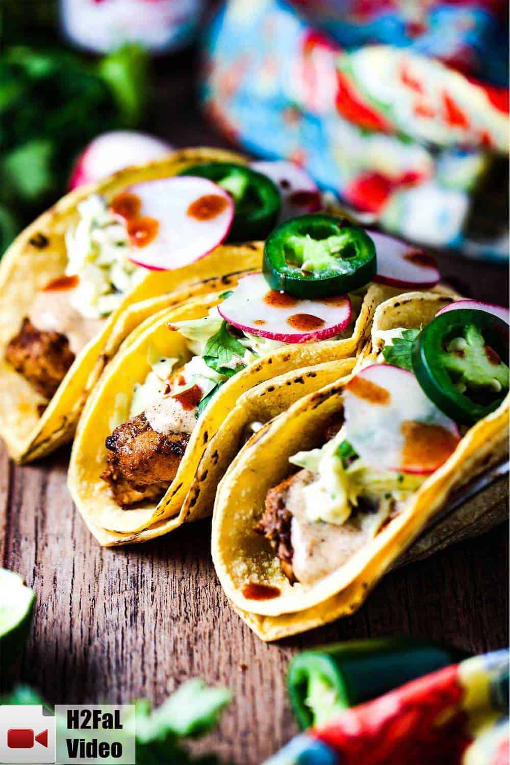 Mahi Mahi tacos on a wooden tables in a taco holder