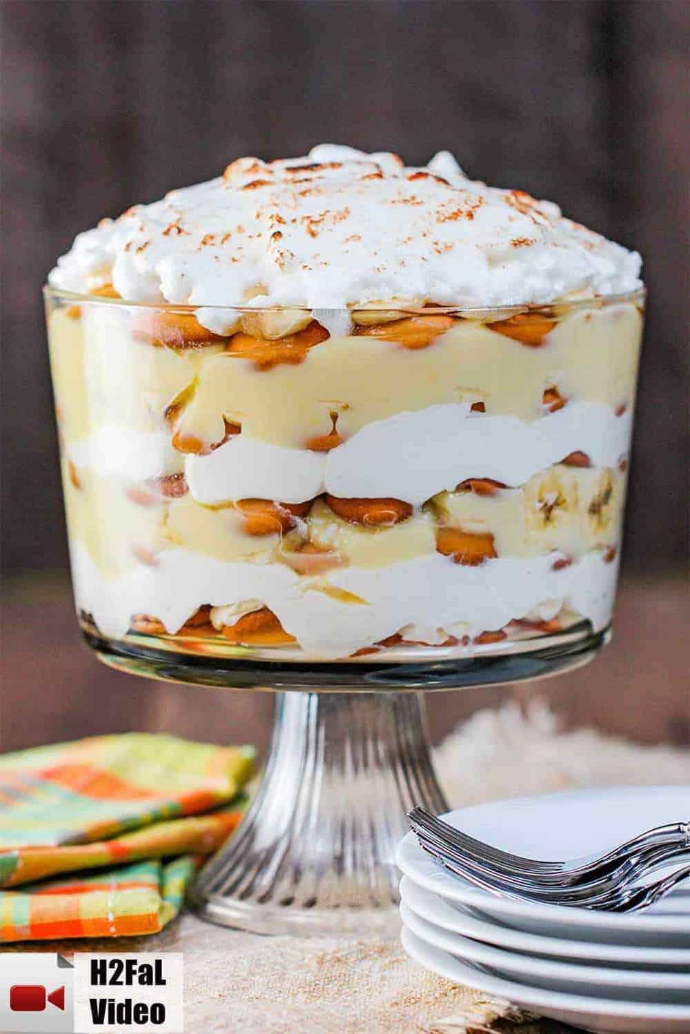 A trifle filled with layers of banana pudding and topped with meringue