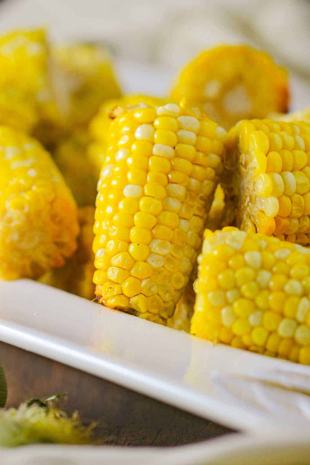 Cooked corn niblets in a white serving bowl. 