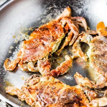 sautéed soft shell crabs in a silve skillet