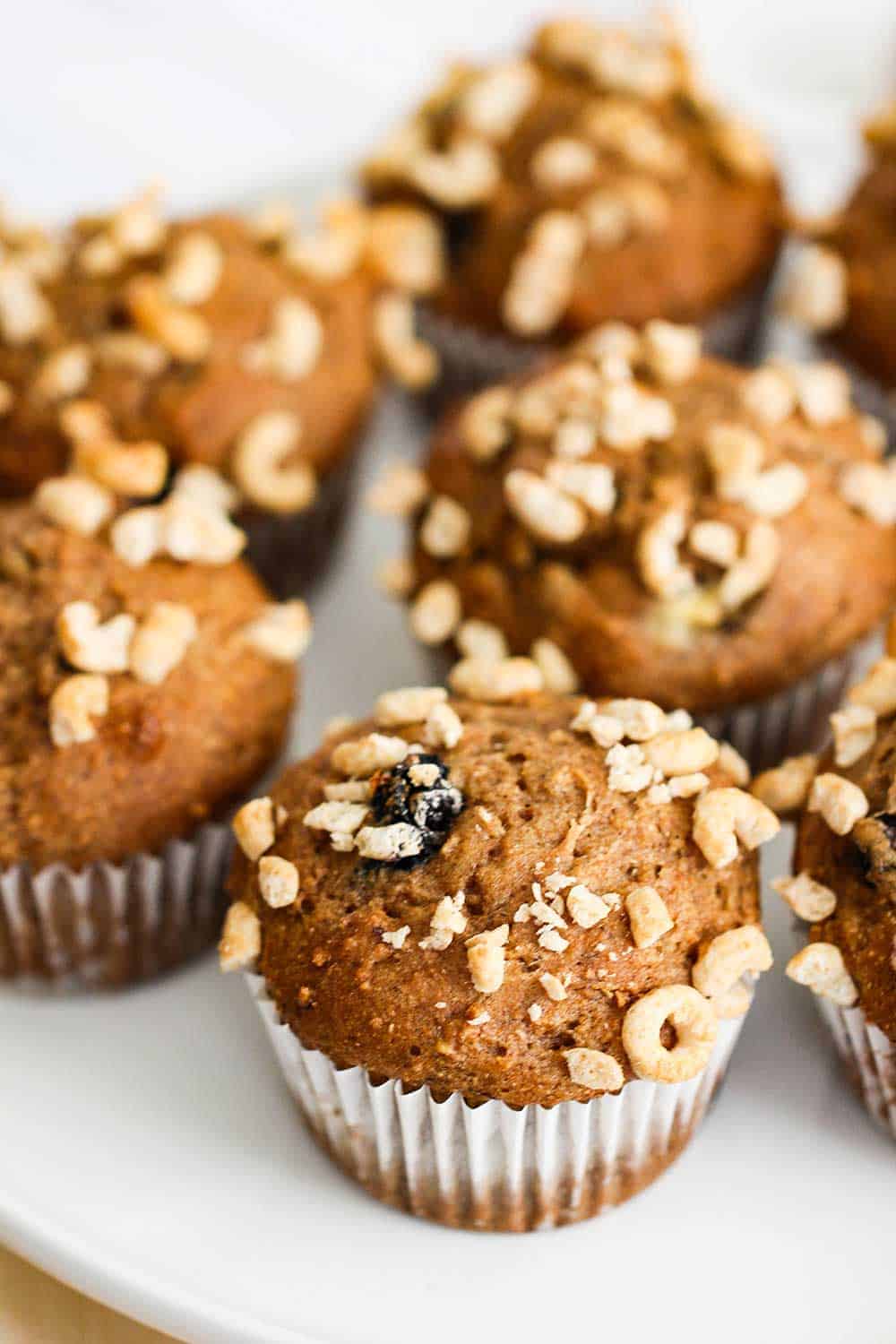 Banana Blueberry Muffins with Honey Nut Cheerios on a white platter. 