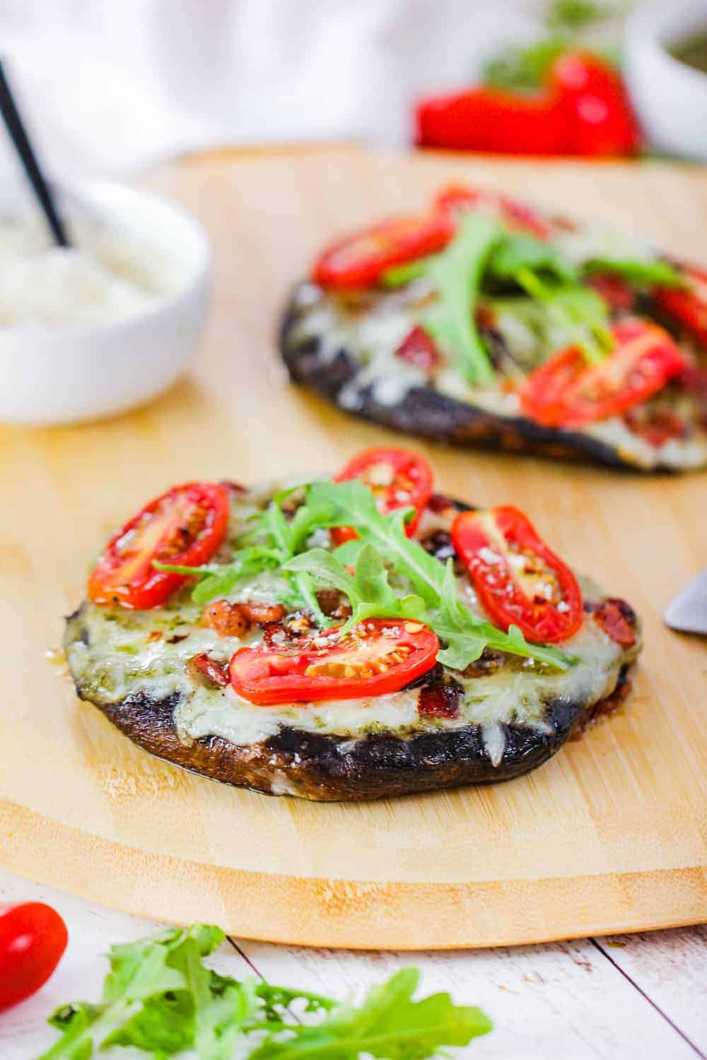 Grilled Portobello BLT Pizzas on a pizza paddle.