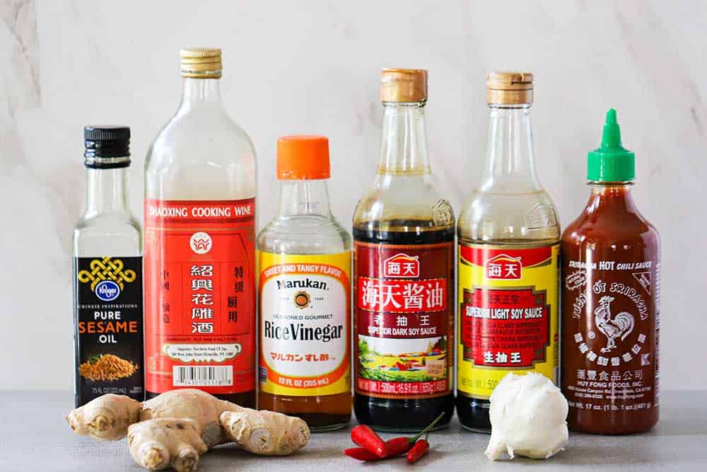 A row of bottles of ingredients for ginger-soy dipping sauce.