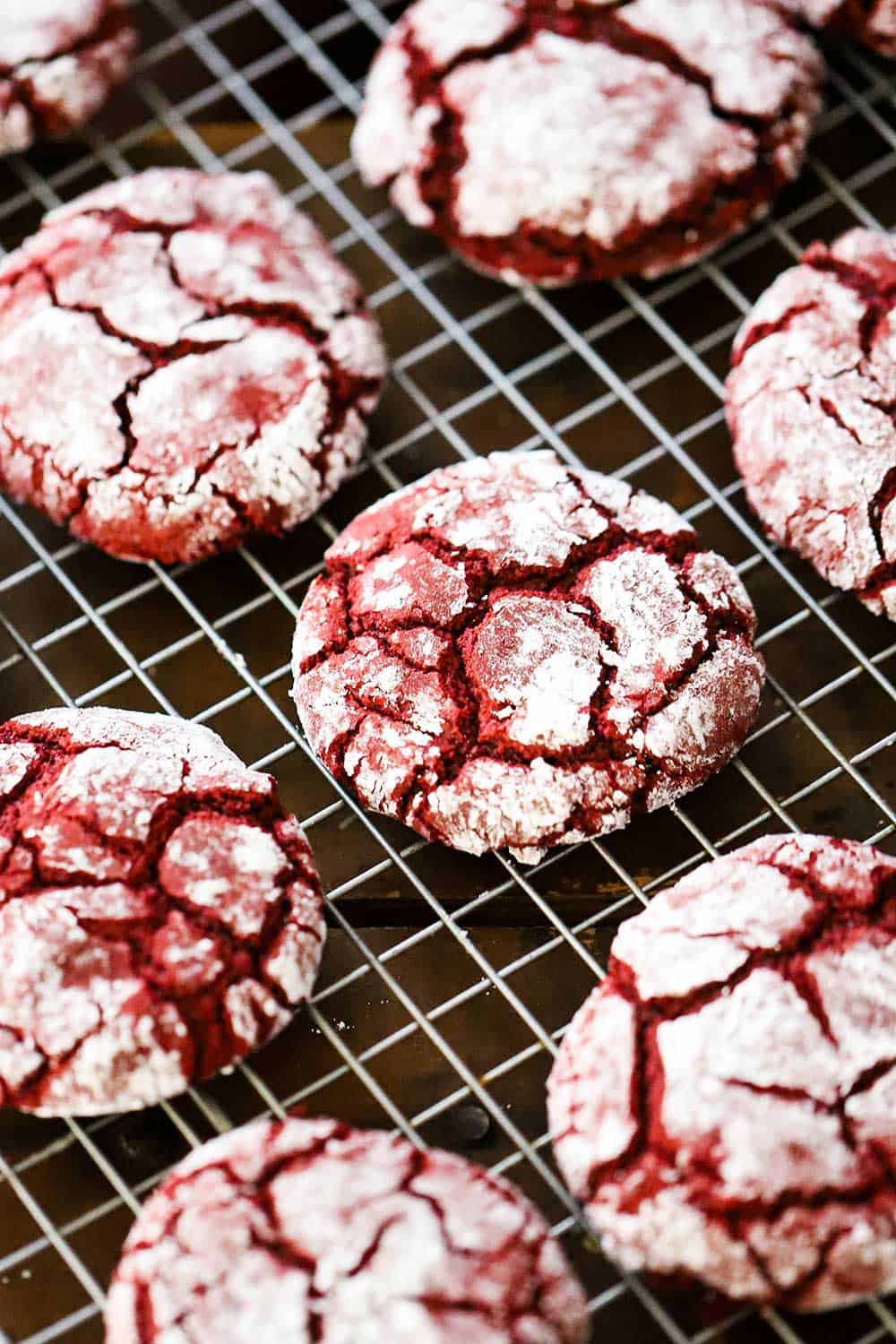 Red velvet cookies cooling on a baking rack. 