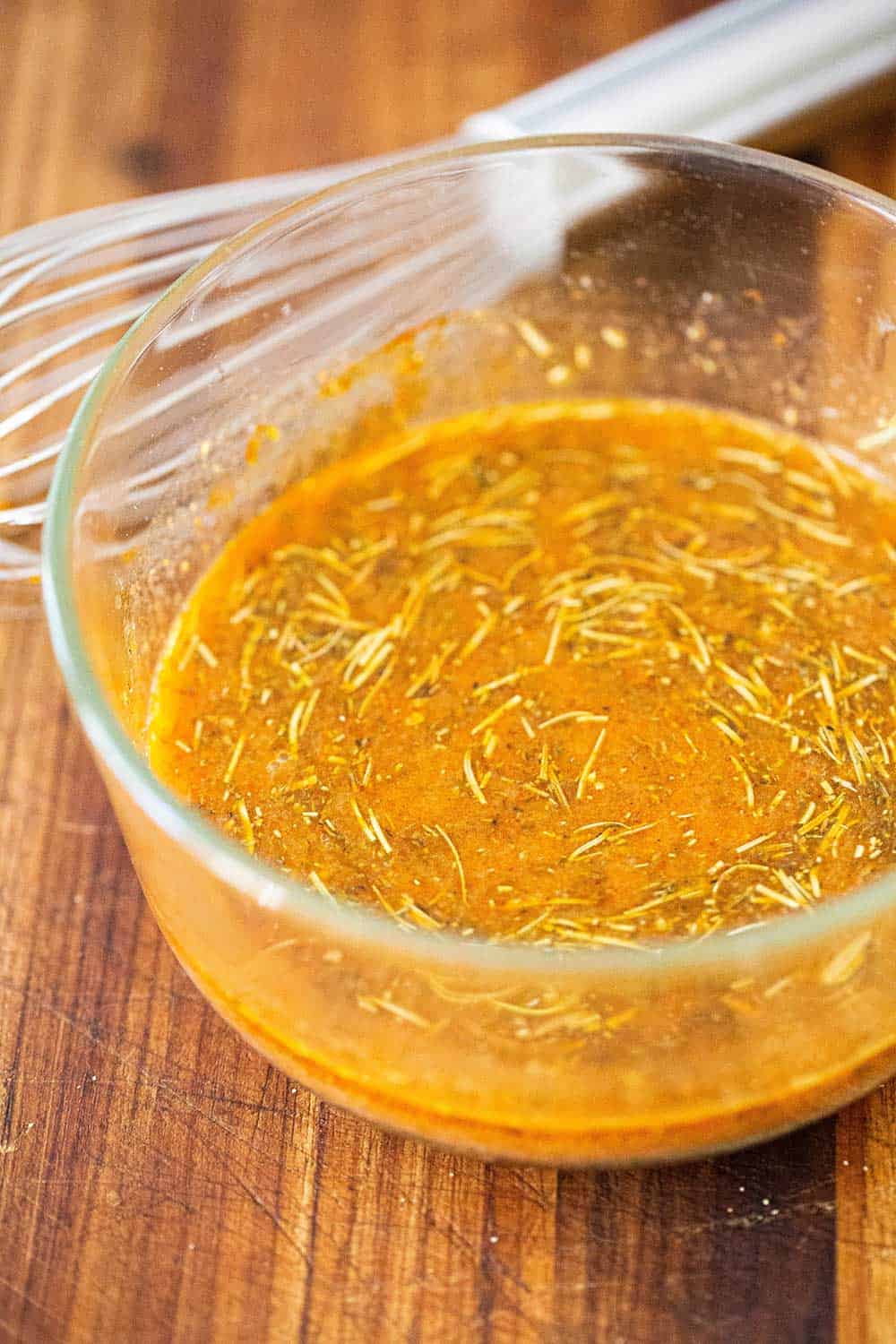 A small glass bowl filled with a paprika lemon juice marinade.