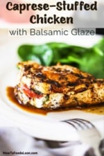 A close-up view of a caprese-stuffed chicken breast with a balsamic glaze on a white dinner plate.