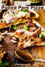 A slice of pulled pork pizza with a bite taken out of it sitting on a cutting board next to a spoon covered in barbecue sauce.