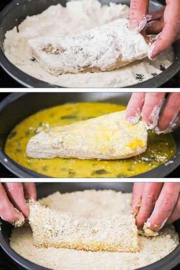 A person dredging a filet of cod through flour and then egg, and then a Panko Parmesan mixture.