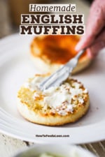 A person using a small knife to smear softened butter on an opened toasted English muffin.