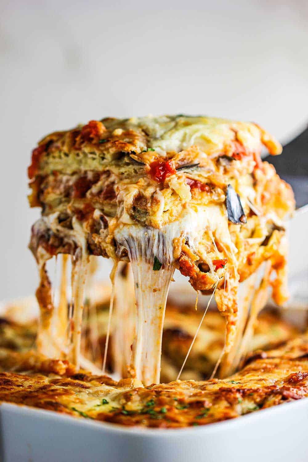 close-up of grated parmesan cheese coming down from the rotating