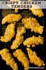 An overhead view of a about ten crispy chicken tenders sitting on a baking rack over a baking sheet.