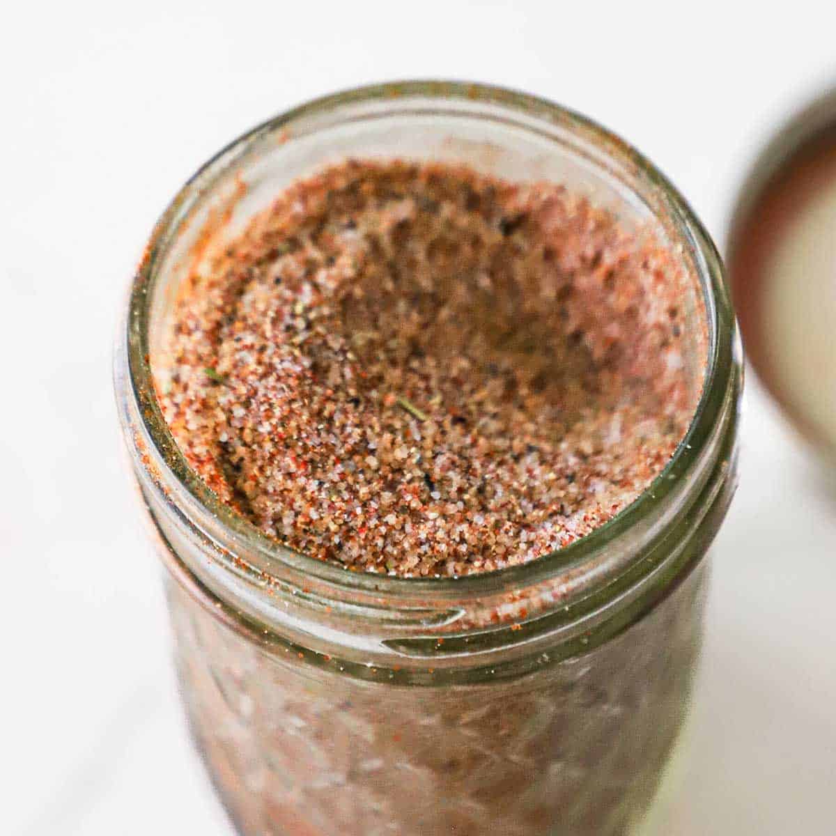 A small glass jar filled to the top with best pork rub.