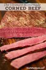 A close-up view of a classic homemade corned beef with several slices revealing the bright red interior of the meat.