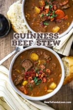 An overhead view of two white soup bowls filled with classic Guinness beef stew.