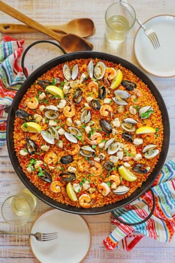 An overhead view of a large paella pan filled with freshly prepared Authentic Spanish Seafood Paella.