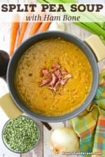 An overhead view of a large circular pot filled with homemade split pea soup with a mound of crispy ham in the center of the soup.