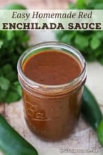 An open jar filled to the top with Easy Homemade Red Enchilada Sauce.