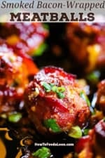 A close-up view of a smoked bacon-wrapped meatball with cheddar and jalapeño in a cast-iron skillet with chopped scallions sprinkled on top.
