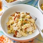 A white pasta bowl filled a serving of creamy chicken bacon ranch casserole