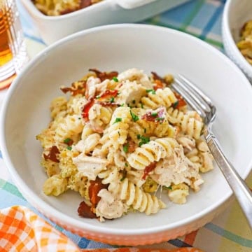 A white pasta bowl filled a serving of creamy chicken bacon ranch casserole