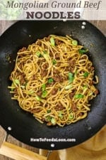 An overhead view of a large wok that is filled with freshly prepared Mongolian Ground Beef Noodles topped with chopped scallions.