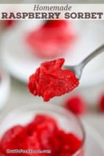 A spoon being used to raise a spoonful of homemade raspberry sorbet above a glass bowl of the same.